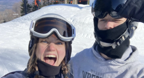 two people in ski helmets and goggles in the winter