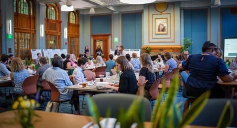 A group of people sitting at tables in the Huddleston Ballroom