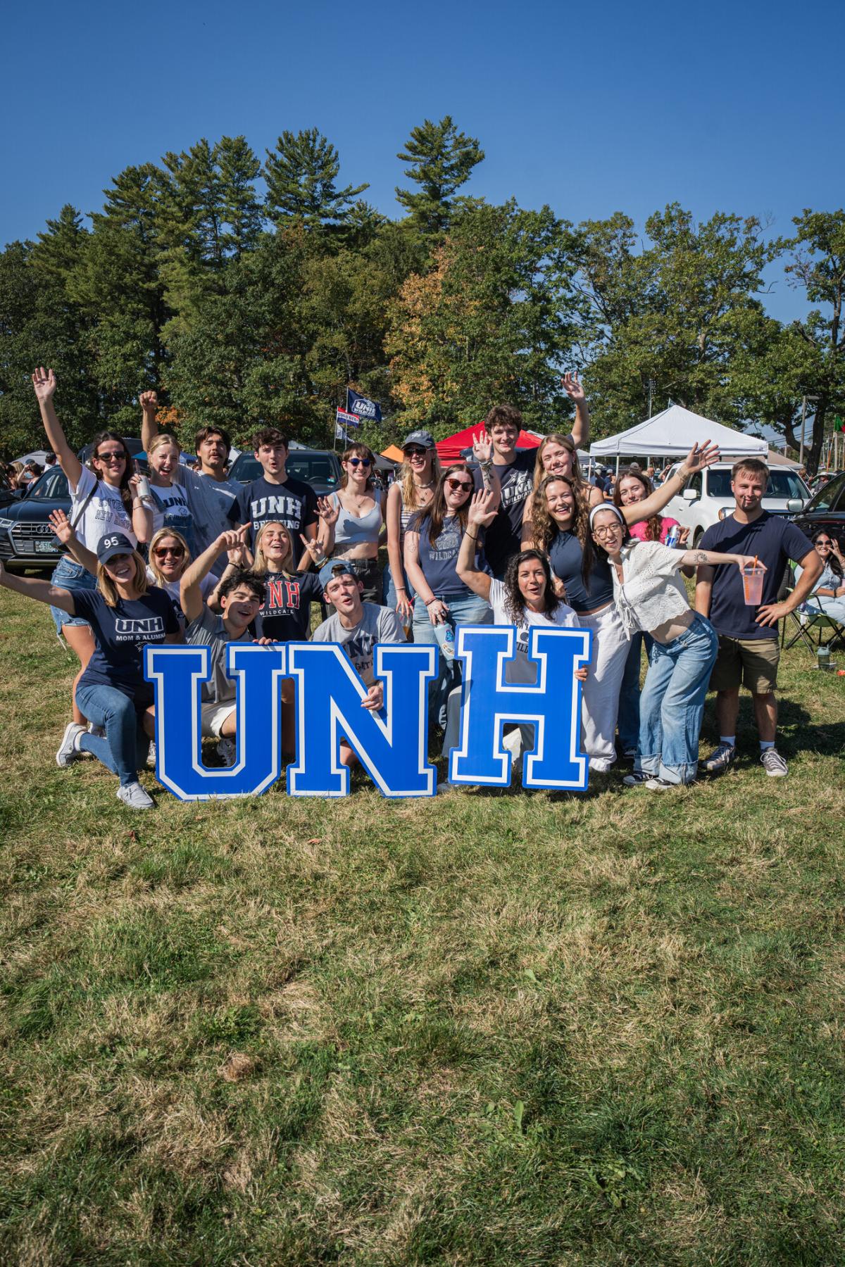 UNH alumni posing for a photo during the 2025 Homecoming football game